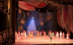 DIPLOMATIC MESSAGE.  The Nutcracker, Tbilisi.  Final scene + curtain call —green Christmas tree becomes white/red Georgian colors with clouds + stars revealed as a US flag.   A point to diplomats in the audience.
